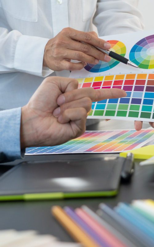 graphic designer or creative working together coloring using graphics tablet and a stylus at desk wi 1